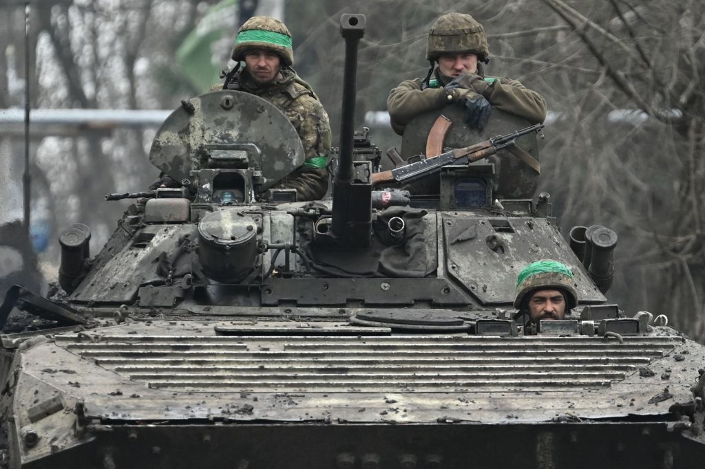 Ukrainian servicemen ride on a BMP infantry fighting vehicle on a road near Bakhmut on April 3, 2023, amid the Russian invasion of Ukraine. 