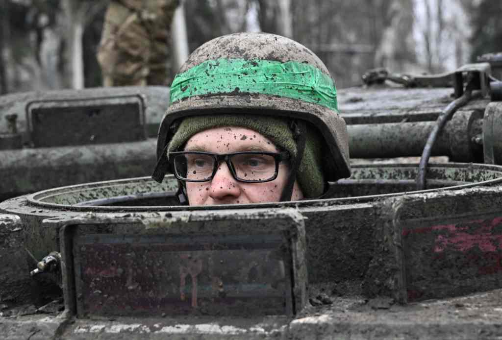 A Ukrainian serviceman looks out of the hatch of an armored personnel carrier in the town of Chasiv Yar, Donetsk region on April 3, 2023, amid the Russian invasion of Ukraine. 