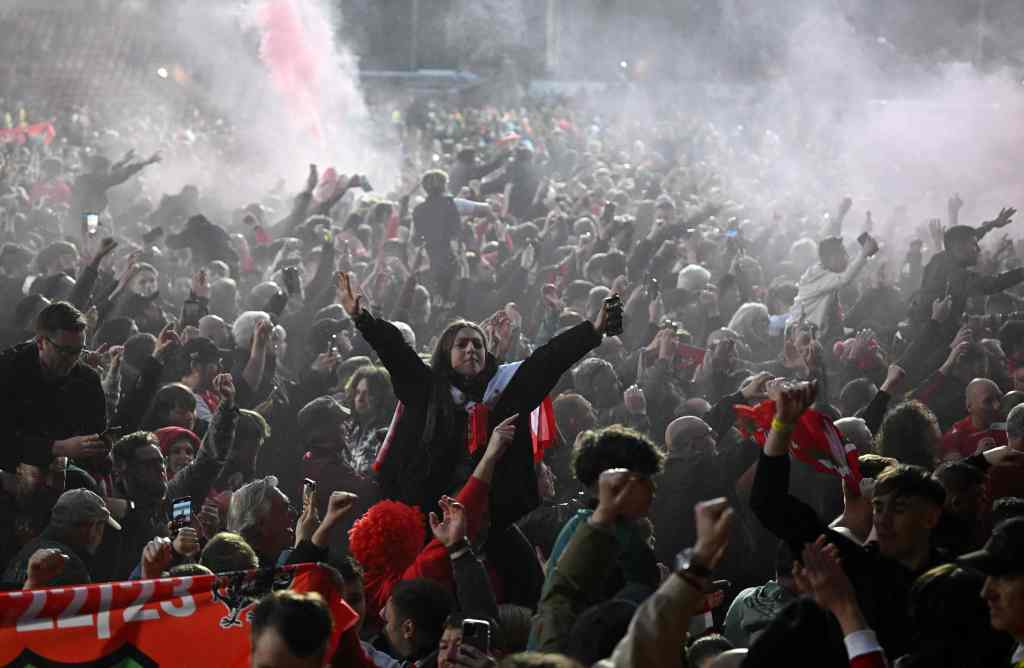 Wrexham's fans celebrate on the pitch after the English National League football match between Wrexham and Boreham Wood.