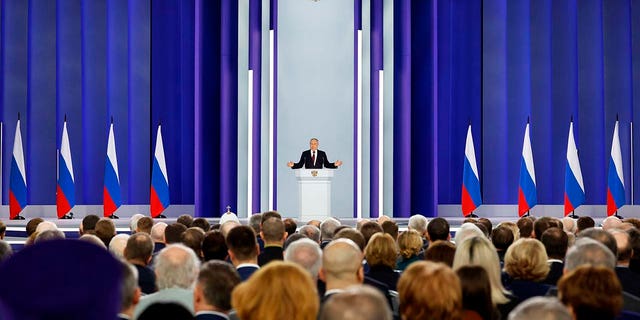 Russian President Vladimir Putin gestures as he gives his annual state of the nation address in Moscow on Feb. 21, 2023.