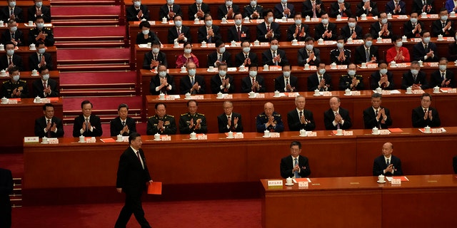 Chinese President Xi Jinping walks to cast his vote during a session of China's National People's Congress to select state leaders at the Great Hall of the People in Beijing.