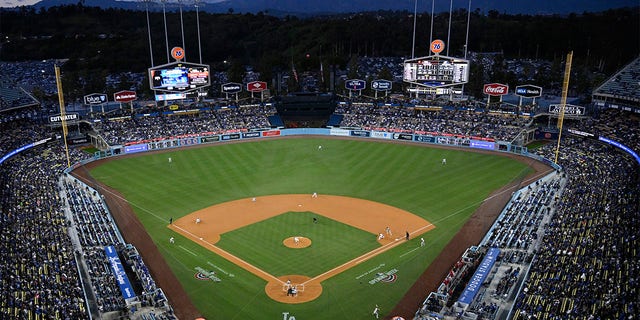 Fans watch at the Los Angeles Dodgers play the Arizona Diamondbacks in the first inning of an opening day baseball game Thursday, March 30, 2023, in Los Angeles. 