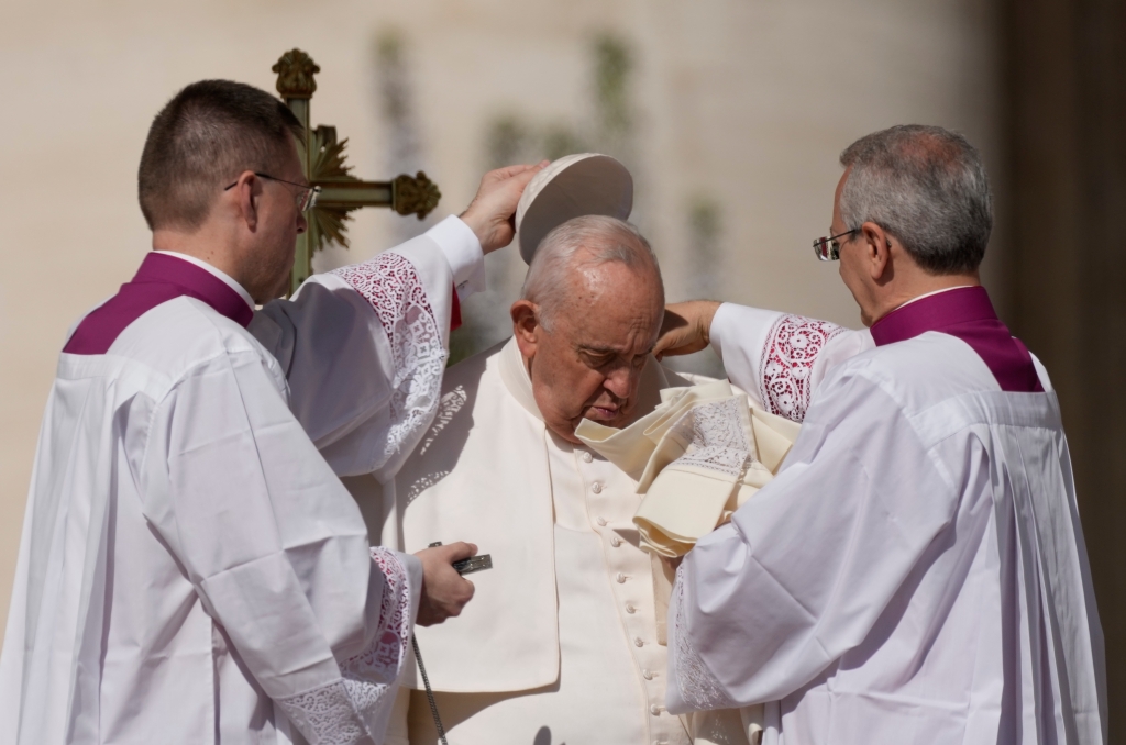 Pope Francis is helped in St. Peter's Square at The Vatican where he will celebrate the Easter Sunday mass on April 9, 2023. 
