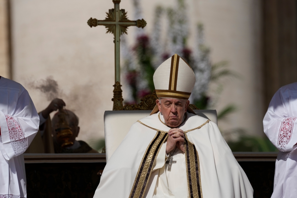 Pope Francis sits on the altar in St. Peter's Square at The Vatican during the Easter Sunday mass on April 9, 2023.
