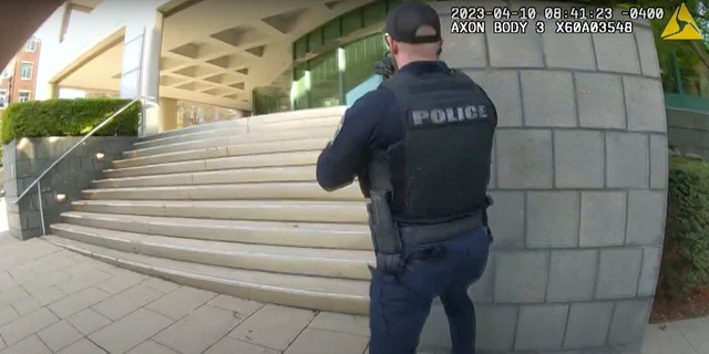 In this screen grab taken from the body cam video of Louisville Metro Police Department Officer Nickolas Wilt, fellow Officer Cory Galloway approaches an active shooting situation, with Wilt following behind him, at Old National Bank, in Louisville, Ky., Monday, April 10, 2023. 