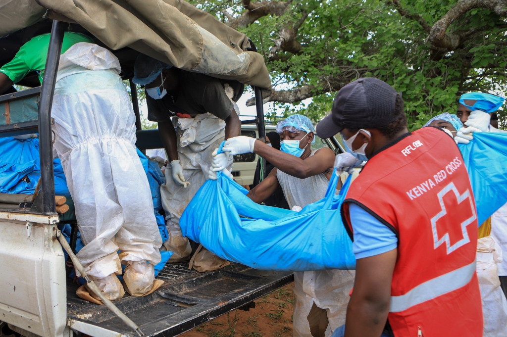 Kenya Red Cross are seen loading more bodies of victims into the back of a truck in the village of Shakahola, near the coastal city of Malindi, in Kenya on April 23, 2023.