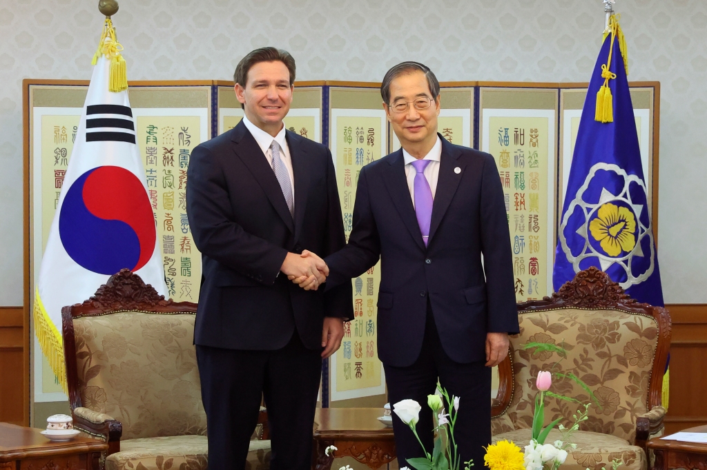 South Korean Prime Minister Han Duck-soo, right, shakes hands with Florida Gov. Ron DeSantis during a meeting at the government complex in Seoul, South Korea, on April 26, 2023.