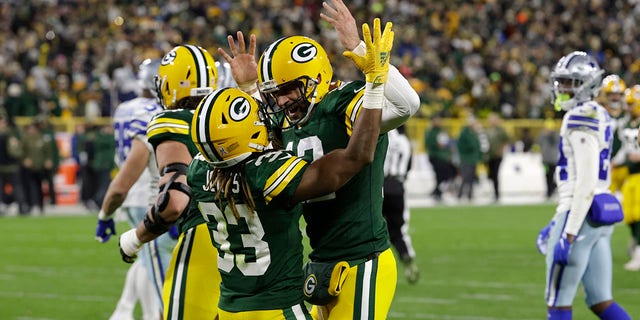 Aaron Jones celebrates with Aaron Rodgers