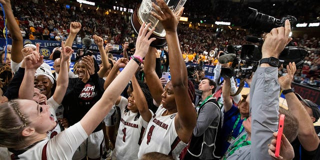 South Carolina's Aliyah Boston holds up the championship trophy after defeating Tennessee 74-58 to win the championship game of the Southeastern Conference Tournament in Greenville, S.C., March 5, 2023.