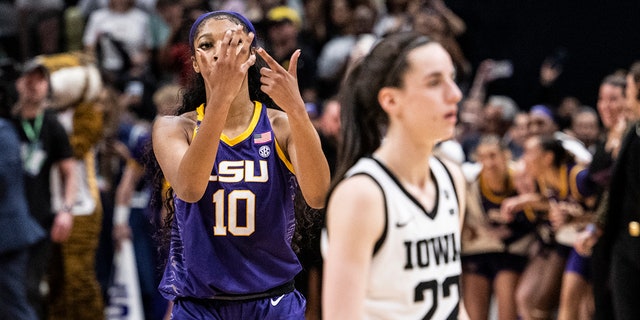 Angel Reese, #10 of the LSU Lady Tigers, reacts in front of Caitlin Clark, #22 of the Iowa Hawkeyes, toward the end of the 2023 NCAA Women's Basketball Tournament championship game at American Airlines Center on April 2, 2023 in Dallas.