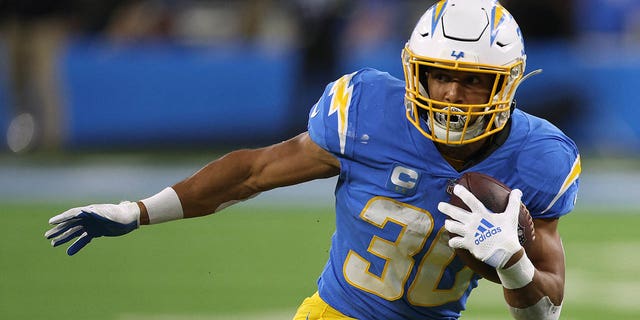 Austin Ekeler #30 of the Los Angeles Chargers runs after his catch during a 23-17 win over the Miami Dolphins at SoFi Stadium on December 11, 2022 in Inglewood, California.