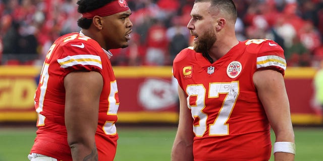 Kansas City Chiefs tight end Travis Kelce (87) and offensive tackle Orlando Brown Jr. (57) after a touchdown in the second quarter of an AFC divisional playoff game against the Jacksonville Jaguars Jan. 21, 2023, at GEHA Field at Arrowhead Stadium.