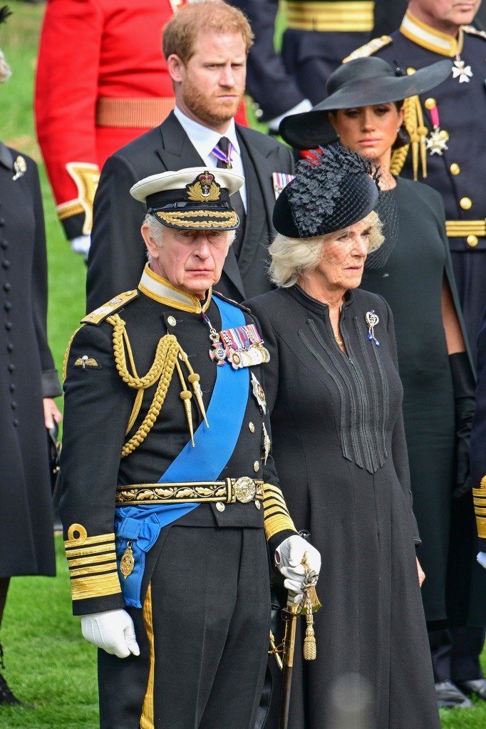 King Charles III and Camilla, Queen Consort observe the coffin of Queen Elizabeth II as it is transferred from the gun carriage to the hearse at Wellington Arch following the State Funeral of Queen Elizabeth II at Westminster Abbey on September 19, 2022 in London, England.