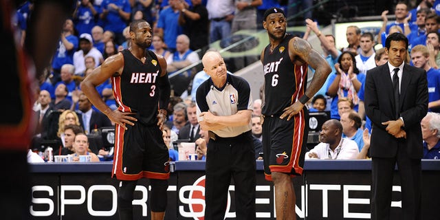 Dwyane Wade stands near LeBron James