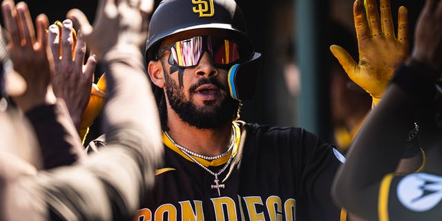 Fernando Tatis Jr. of the San Diego Padres celebrates in the dugout after hitting a home run during a spring training game against the Los Angeles Angels on March 24, 2023, in Tempe, Arizona.