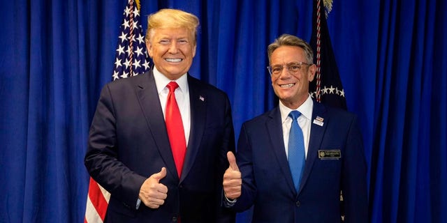 President Donald Trump poses with state Rep. Fred Doucette ahead of a rally in Manchester, New Hampshire, on Feb. 11, 2020.