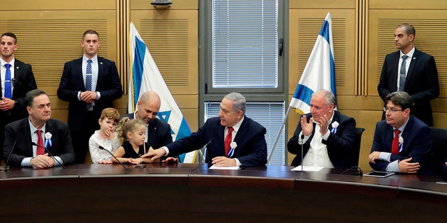 Israeli Prime Minister Benjamin Netanyahu, center, next to Justice Minister Amir Ohana, center-left, at the Knesset in Jerusalem on October 3, 2019. 