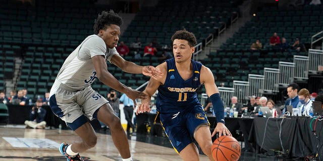 Quinnipiac Bobcats Guard Dezi Jones (11) dribbles the ball against St. Peter's Peacocks Guard Jaylen Murray (32) during the first half of a MAAC Conference basketball tournament quarterfinal game March 11, 2022, at Boardwalk Hall in Atlantic City, N.J.