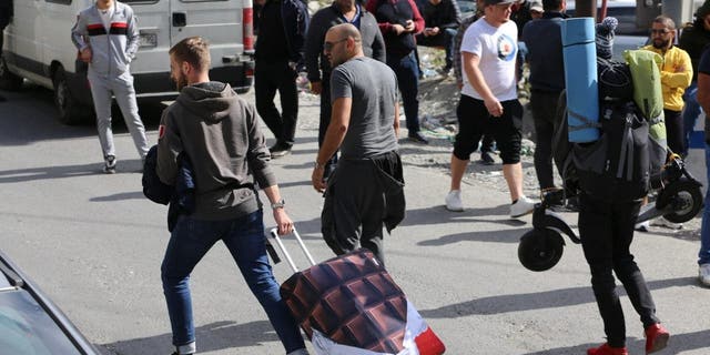 Russians are seen attempting to leave their country at the Kazbegi border crossing in Stepantsminda, Georgia, on Sept. 30, 2022. They were seeking to avoid a military call-up for the Russia-Ukraine war.