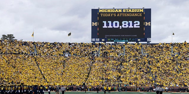 Attendance is shown on the scoreboard during a college football game between the Michigan Wolverines and the Penn State Nittany Lions on October 15, 2022, at Michigan Stadium in Ann Arbor, Michigan. 