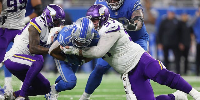 Detroit Lions wide receiver Amon-Ra St. Brown, #14, is tackled by Minnesota Vikings defensive tackle Harrison Phillips, #97, during the second half of an NFL football game in Detroit, Michigan USA, on Sunday, Dec. 11, 2022.