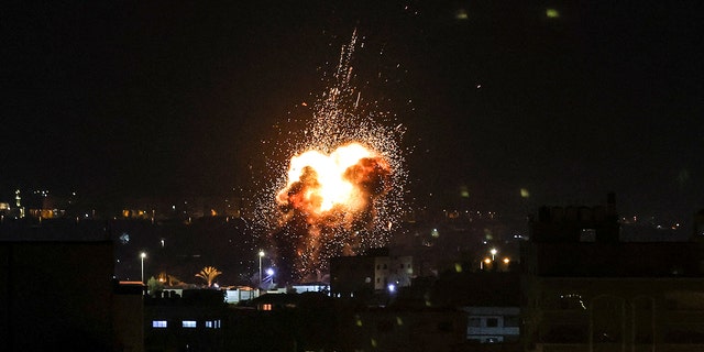 Fire and smoke rise above buildings in Gaza City as Israel launched air strikes on the Palestinian enclave early on January 27, 2023.