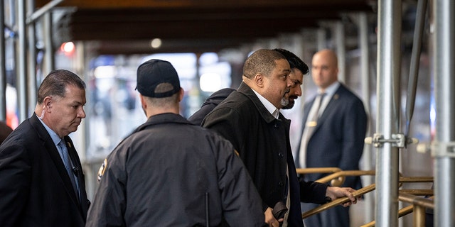 Manhattan District Attorney Alvin Bragg, right, arrives at Manhattan Criminal Court.