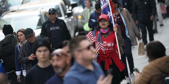 A supporter of former President Donald Trump stands outside Trump Tower in New York on April 3, 2023.