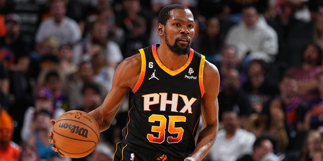 Kevin Durant of the Phoenix Suns dribbles during the game against the Denver Nuggets at the Ball Arena in Denver on April 6, 2023. 