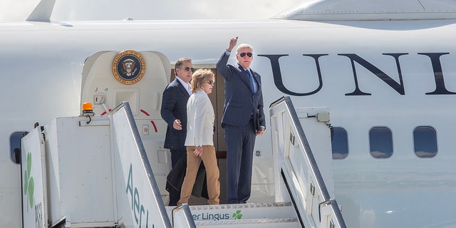 Joe Biden waving while boarding Air Force One