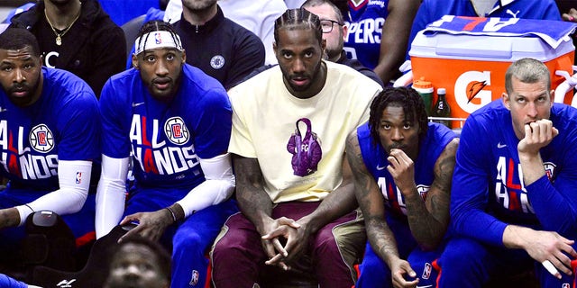 Kawhi Leonard looks on from the bench during a playoff game