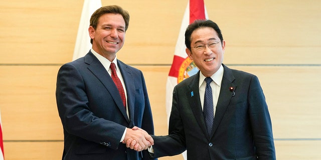 DeSantis and Fumio Kishida shaking hands