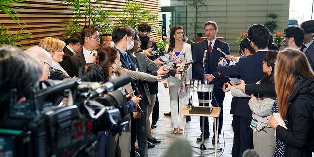 Ron DeSantis with reporters in Japan