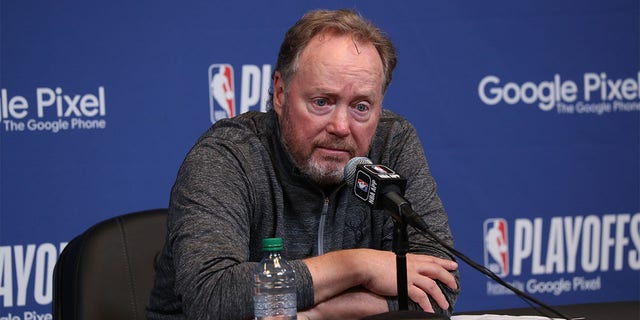 Mike Budenholzer talks to the media