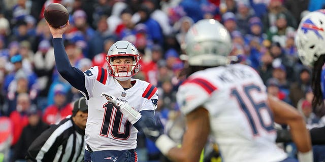 Mac Jones (10) of the New England Patriots attempts a pass during the third quarter against the Buffalo Bills at Highmark Stadium Jan. 8, 2023, in Orchard Park, N.Y. 