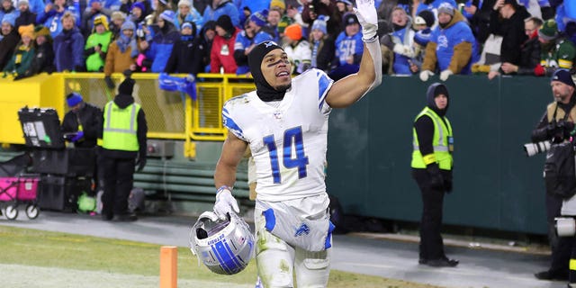 Amon-Ra St. Brown, #14 of the Detroit Lions, greets fans after defeating the Green Bay Packers at Lambeau Field on Jan. 8, 2023 in Green Bay, Wisconsin.