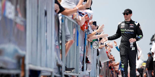 Cody Ware, driver of the #51 PublicSq Ford, greets fans on the red carpet prior to the NASCAR Cup Series EchoPark Automotive Grand Prix at Circuit of The Americas on March 26, 2023 in Austin, Texas. 