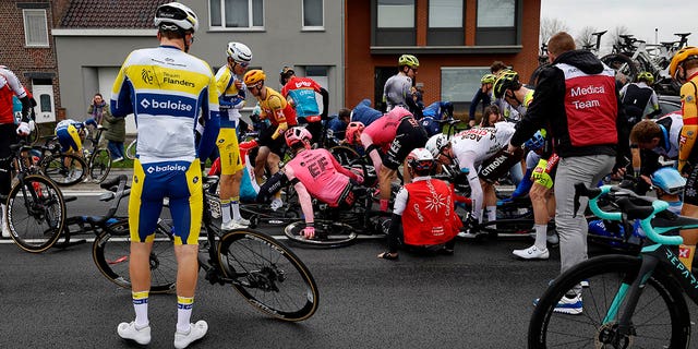 Jenno Berckmoes of Belgium and Team Flanders-Baloise, Stan Dewulf of Belgium and Ag2R Citroën Team, Martin Urianstad Bugge of Norway and Uno-X Pro Cycling Team and the peloton after being involved in a crash during the 107th Ronde van Vlaanderen - Tour des Flandres 2023, Men's Elite a 273.4km one day race from Brugge to Oudenaarde / #UCIWT / on April 02, 2023 in Brugge, Belgium.