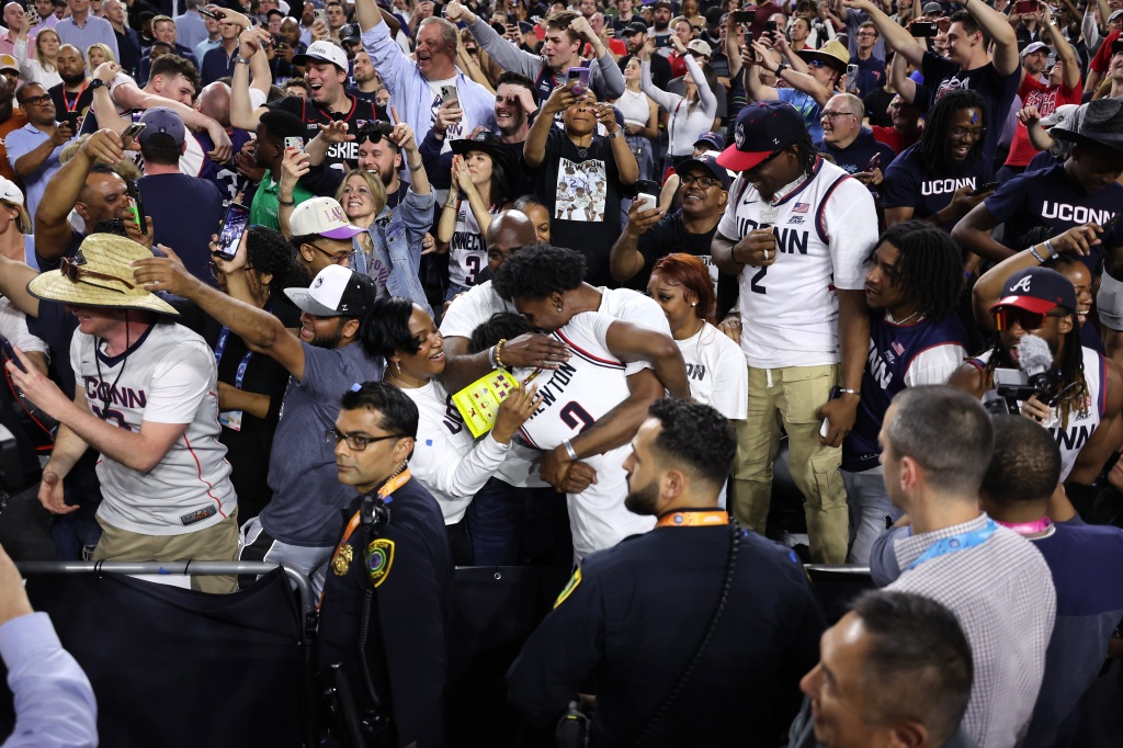 Tristen Newton #2 of UConn celebrates with family after defeating the San Diego State Aztecs 76-59 at NRG Stadium on April 3, 2023 in Houston. 