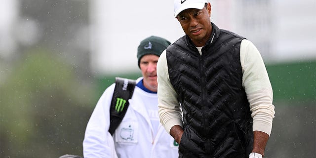 Tiger Woods of the United States looks on from the 18th green during the continuation of the weather delayed second round of the 2023 Masters Tournament at Augusta National Golf Club on April 8, 2023, in Augusta, Georgia. 