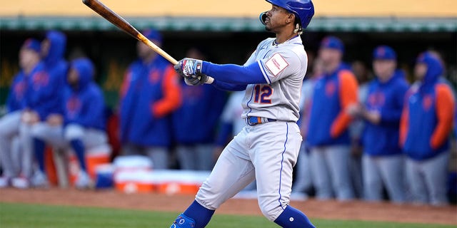 Francisco Lindor, #12 of the New York Mets, hits a grand slam home run against the Oakland Athletics in the top of the second inning at RingCentral Coliseum on April 14, 2023, in Oakland, California. 