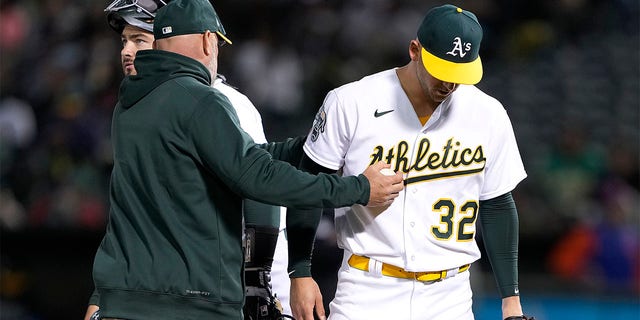 Mark Kotsay, manager of the Oakland Athletics, takes the ball from starting pitcher James Kaprielian, #32, taking him out of the game against the New York Mets in the top of the fourth inning at RingCentral Coliseum on April 14, 2023, in Oakland, California. 