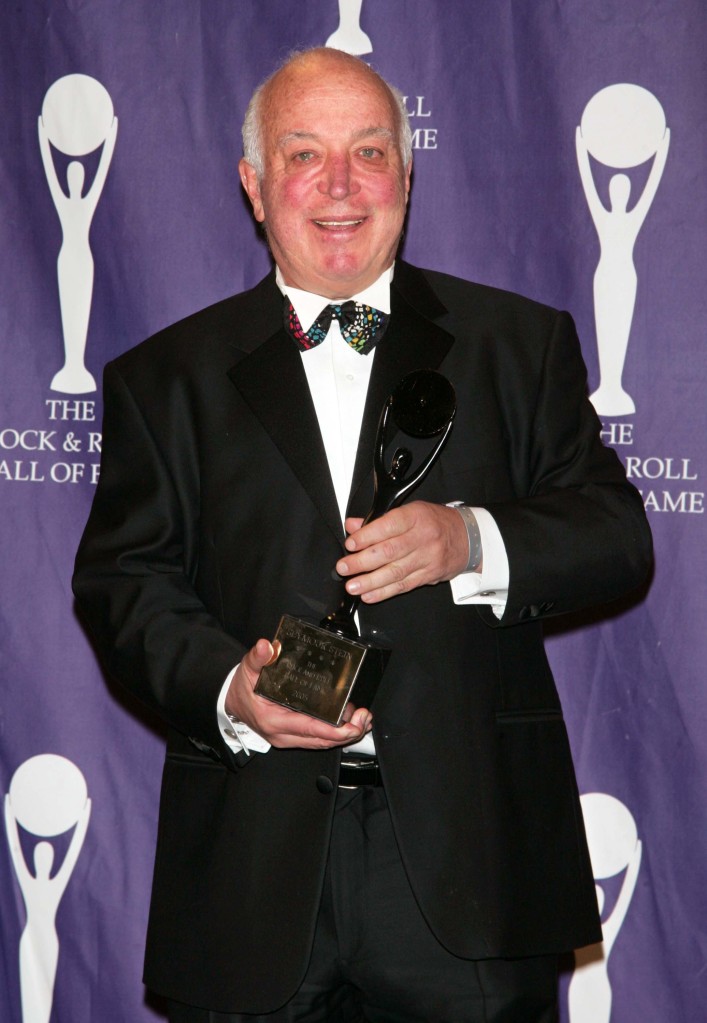 Seymour Stein, inductee and CEO/co-founder of Sire Records, hoists his award at the 20th Annual Rock and Roll Hall of Fame Induction Ceremony. 