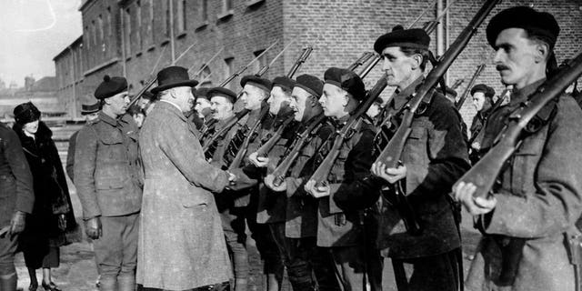 Sir H. Greenwood inspects the British soldiers in Ireland known as the "Black and Tans."