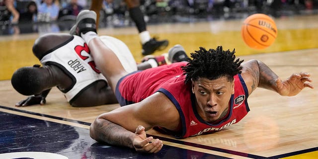 Florida Atlantic forward Giancarlo Rosado, right, falls over San Diego State forward Aguek Arop during the first half of a Final Four college basketball game in the NCAA Tournament on Saturday, April 1, 2023, in Houston. 