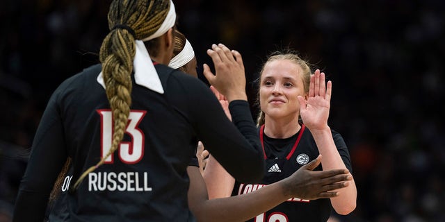 Louisville guard Hailey Van Lith is congratulated by teammates during the Elite 8 game against Iowa in the NCAA Tournament, March 26, 2023, in Seattle.