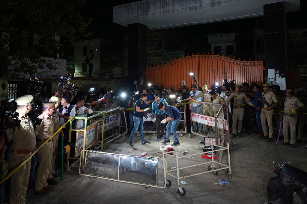 Forensic investigators on the scene marking and gathering evidence after the shooting at Motilal Nehru medical college in, Prayagraj, India, on April 15, 2023.