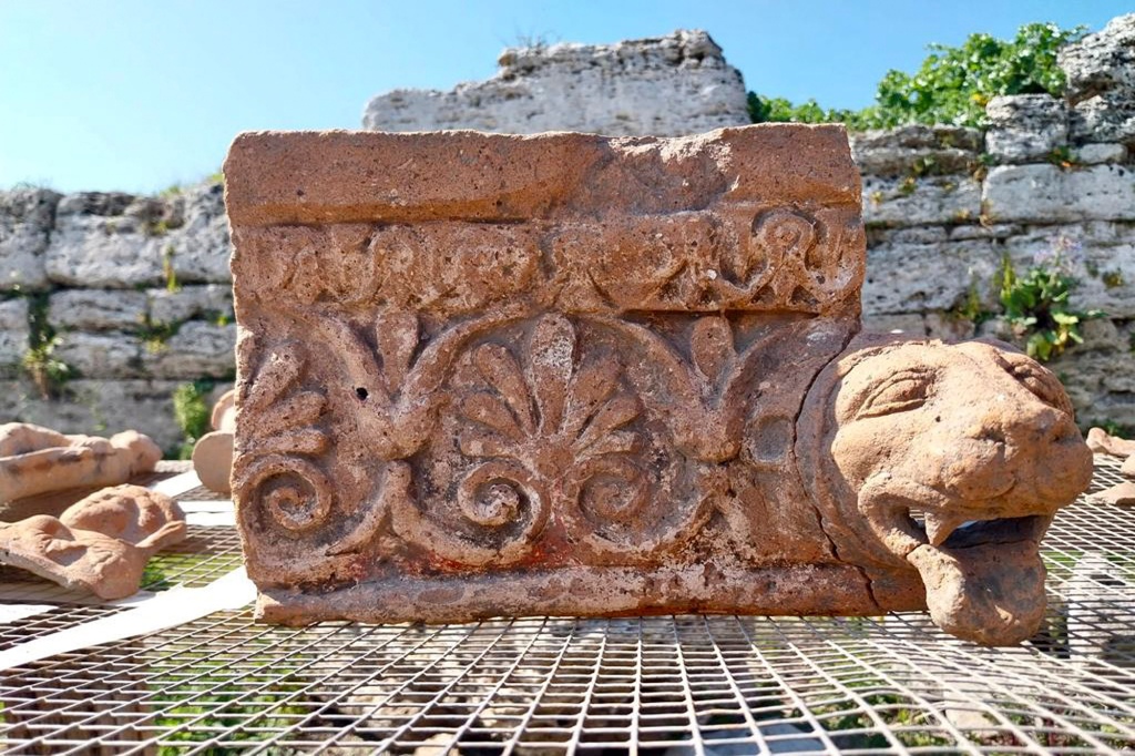 This undated photo shows an architectural element with a leonine protome drip found in a newly discovered sanctuary, which dates from the 5th century B.C., that was first identified in 2019 along the ancient city walls of Paestum, Southern Italy.