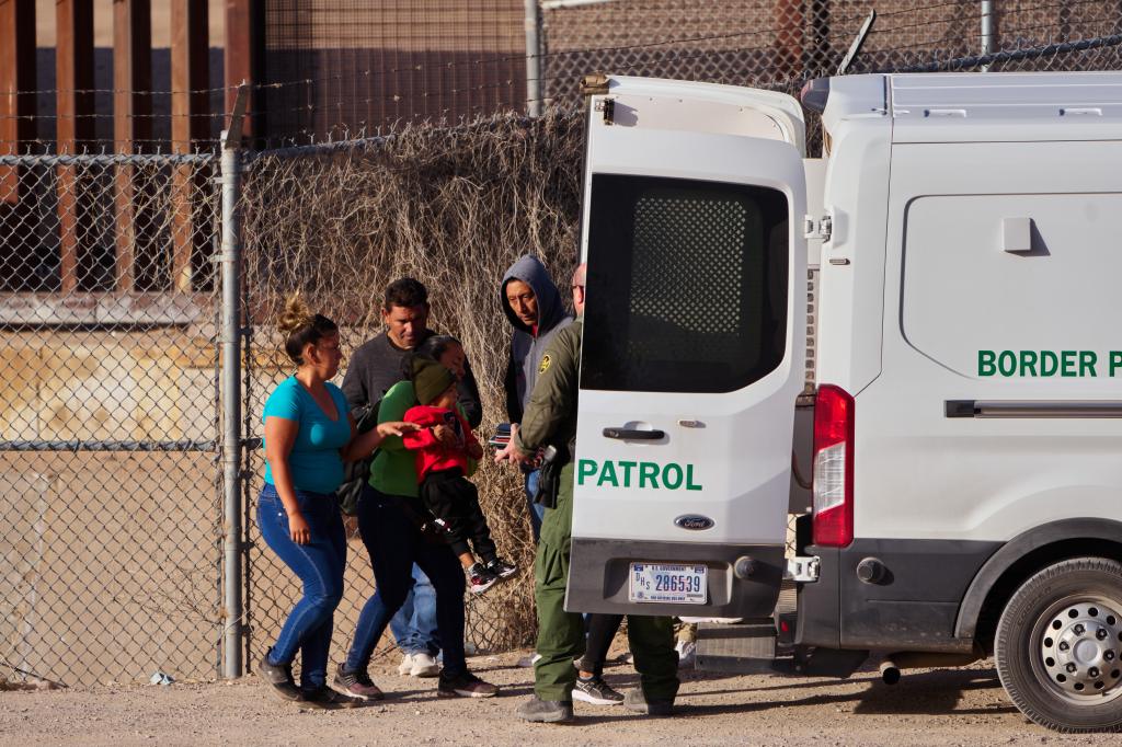 U.S. Customs and Border Protection officers transported migrants for processing after they crossed the U.S.-Mexico border.