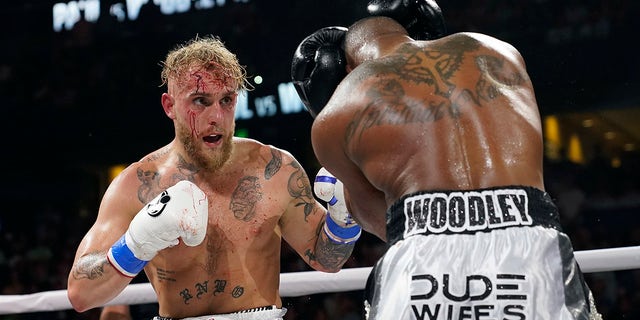 Jake Paul, left, punches Tyron Woodley during the second round of a cruiserweight fight Dec. 19, 2021, in Tampa, Fla.